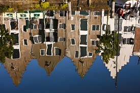 Amsterdam canal houses reflected in water