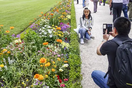 Flower beds and tourists in the Residenz Gardens, Wuerzburg
