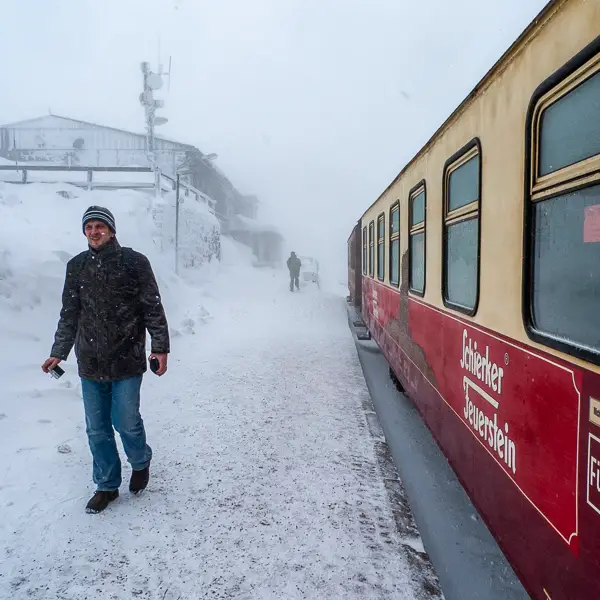 A tourist braves an early snowfall at the Brocken railroad station in the Harz Mountains. The station is next to a former East German listening post that is now open to visitors.