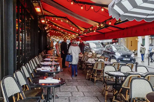 Cafe with red awnings in the rue de Buci, Paris.