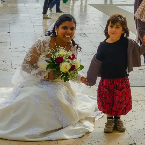 A bride poses with a little girl at the Jardins du Trocadéro in the 16th arrondissement.