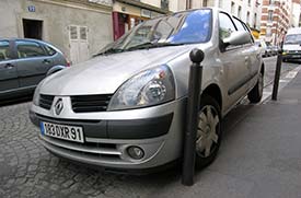 Car parked against post in Paris