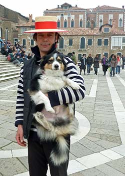 Gondolier and dog by the steps of the Salute Church, Venice.