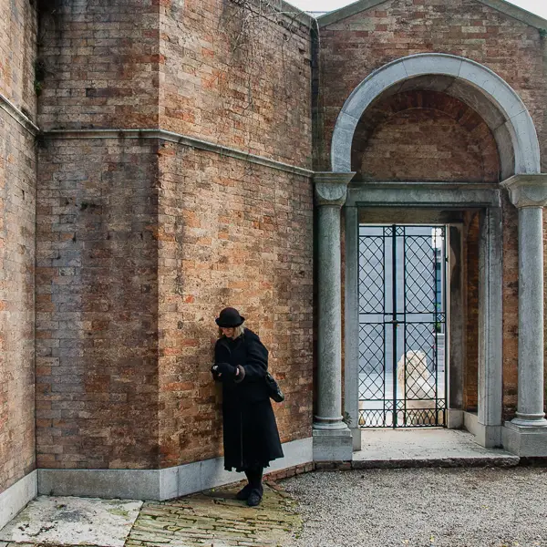  Cheryl Imboden stands inside San Michele cemetery near one of the island's gates, which provide views of the Venetian Lagoon and central Venice.