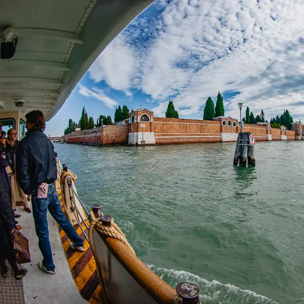 A public water bus approaches the cemetery island of San Michele in Venice, Italy.