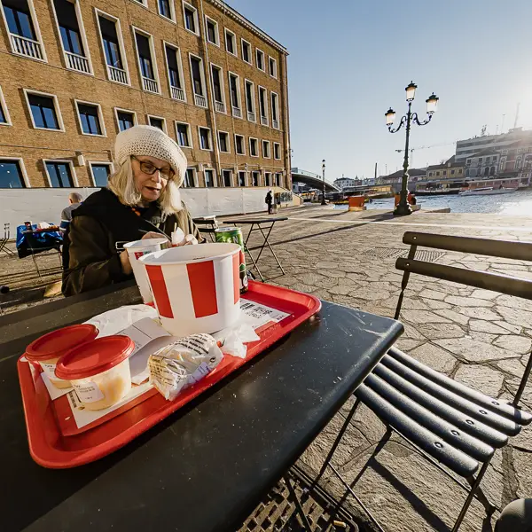  Cheryl Imboden enjoys an alfresco meal at the KFC behind Venice's main railroad station.