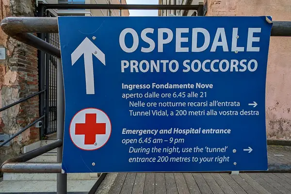 Sign by emergency room entrance at Venice's Ospedale.