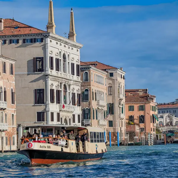 An ACTV Line 2 vaporetto travels up the Grand Canal near the Rialto Bridge in Venice, Italy.