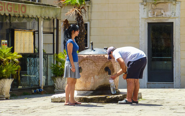 Filling a water bottle at a Venice fountain
